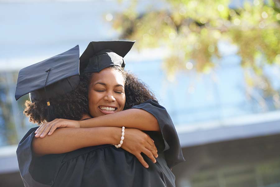 Graduate hugging a friend